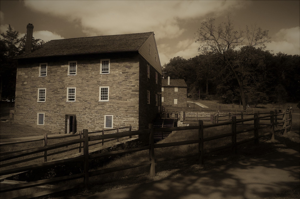 Sepia-toned photograph of Peirce Mill with the barn in the distance.
