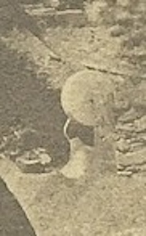 Old, grainy image of a round sharpening stone