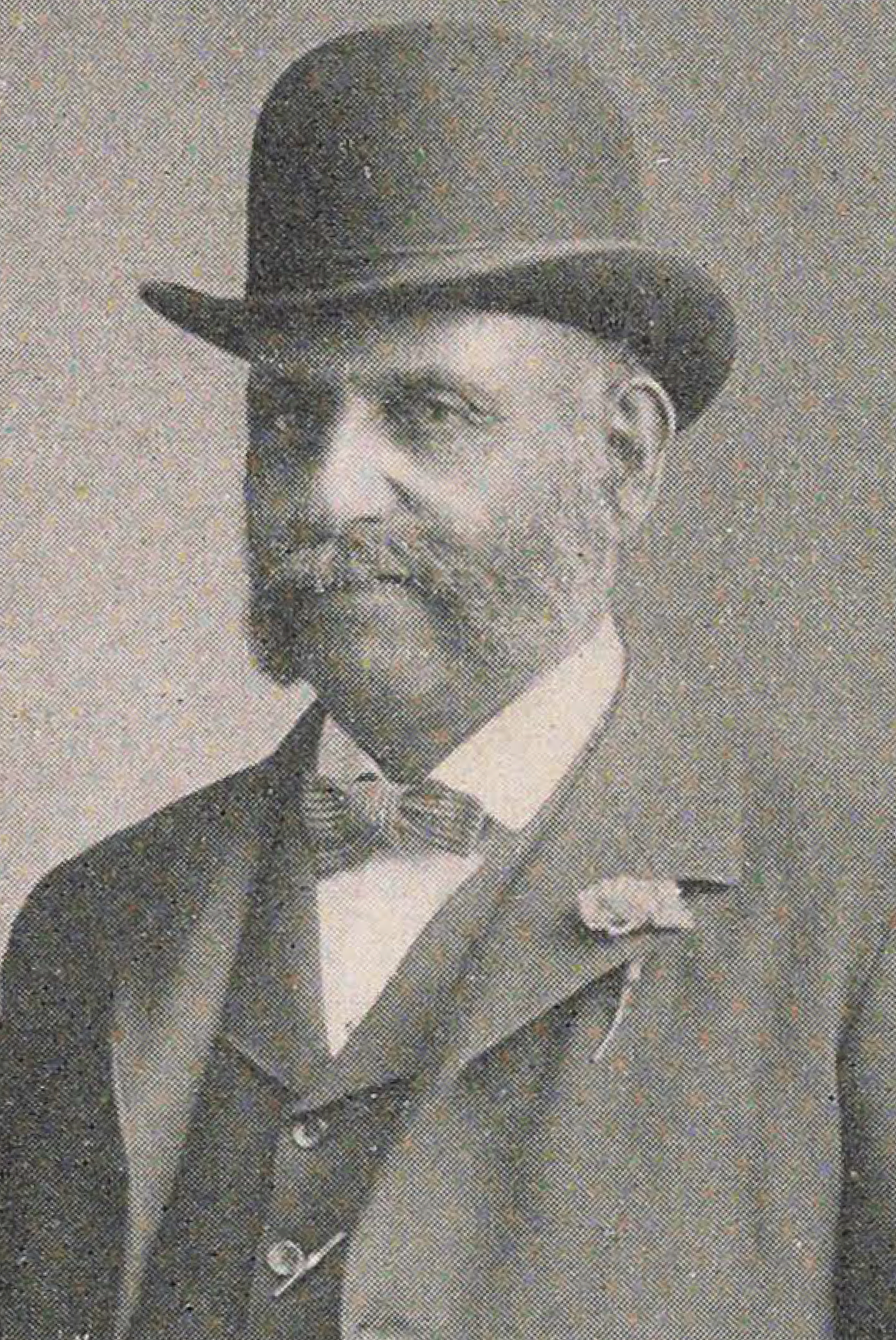 Old black and white photograph of a distinguished looking older man with a bowler hat and bushy whiskers.