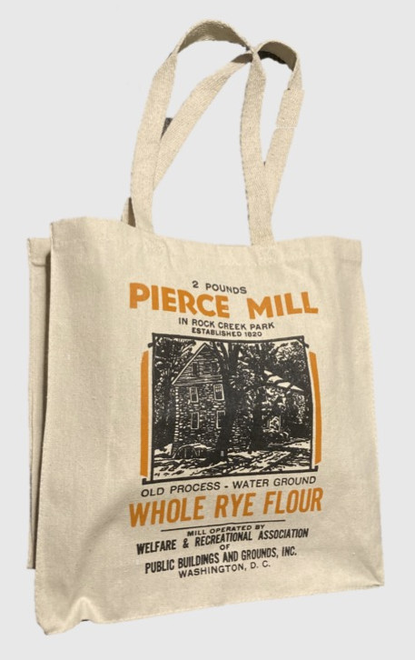 Photograph of a tote bag printed with an old-fashioned black and white label: Pierce Mill Whole Rye Flour."