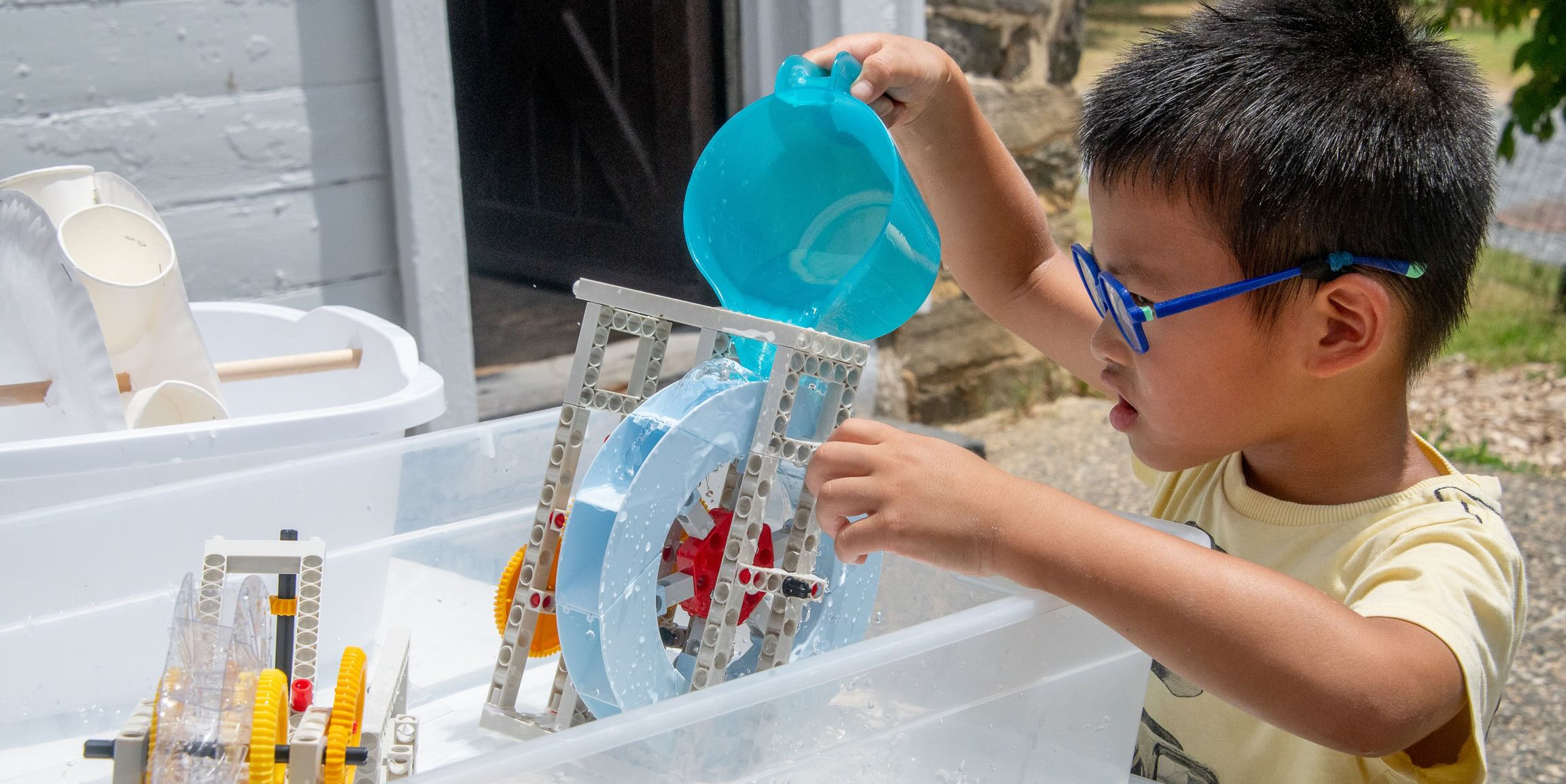 Child experimenting with water toys