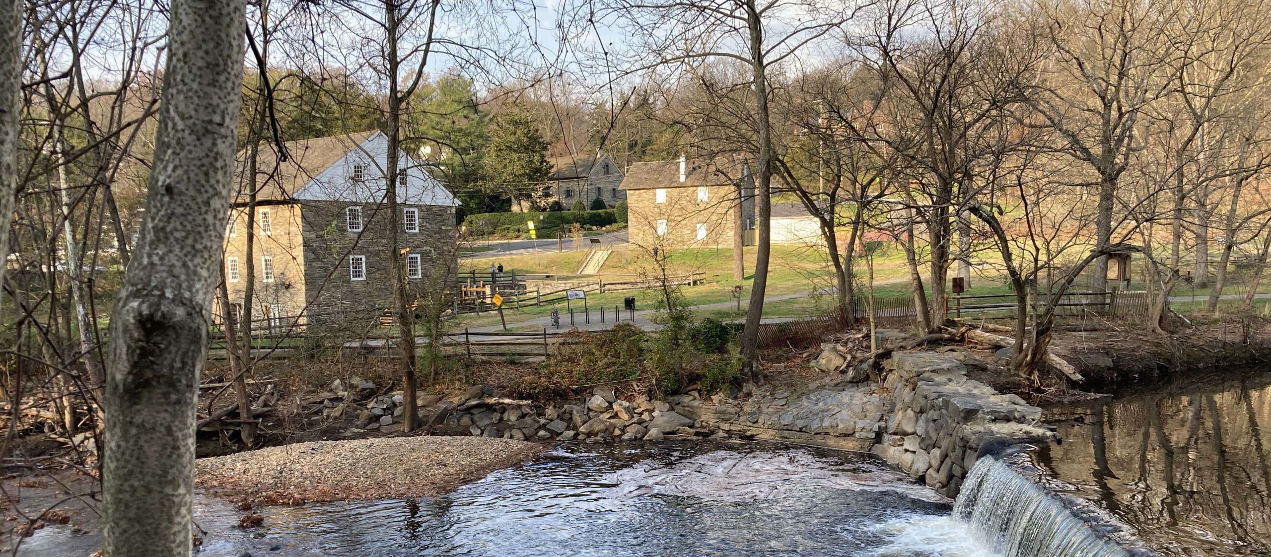Photograph of Peirce Mill in the fall taken from across Rock Creek