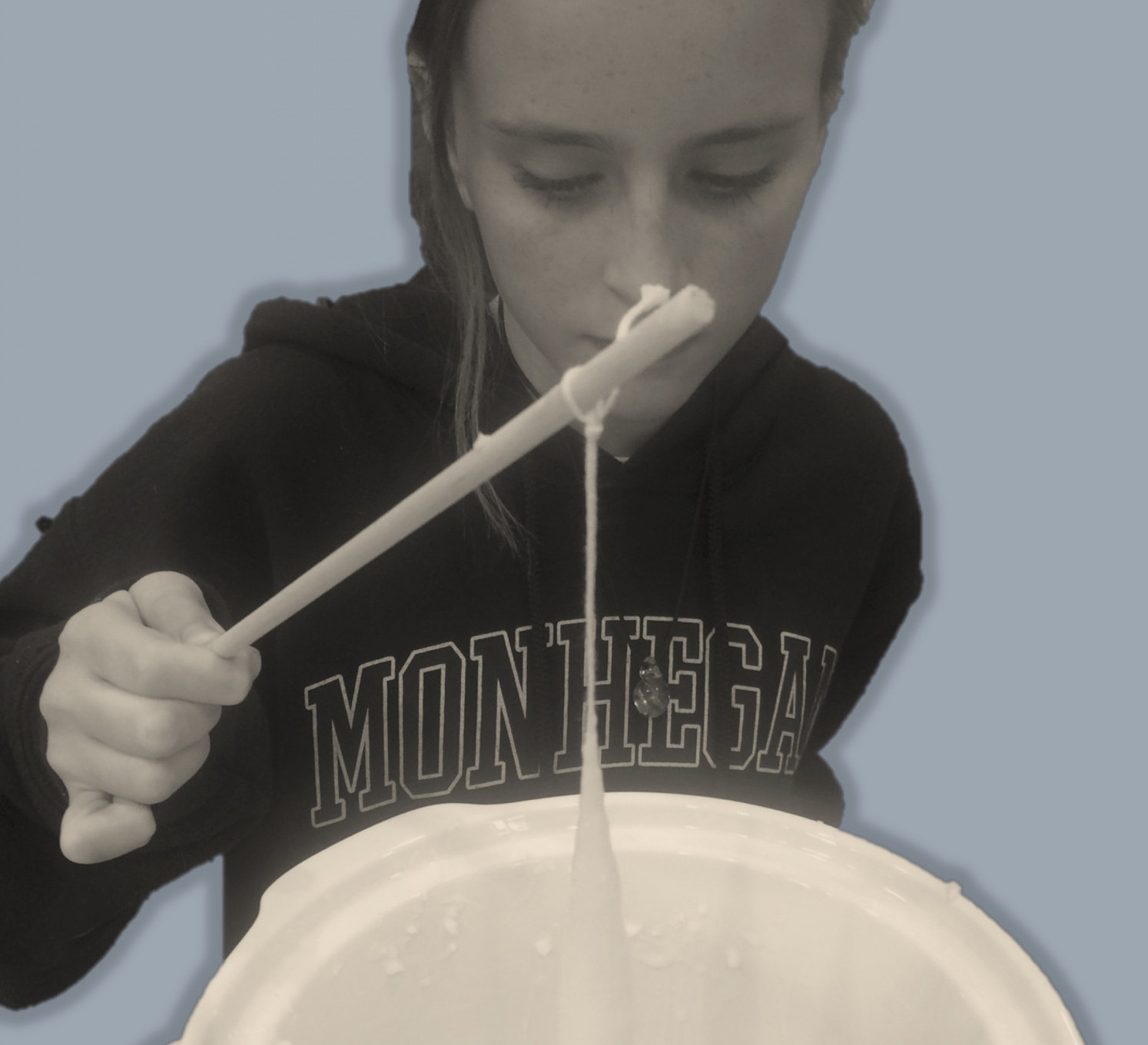 Girl making candles using a crockpot.