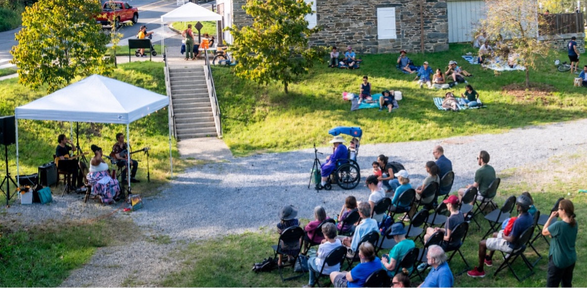 People attend a concert in a park